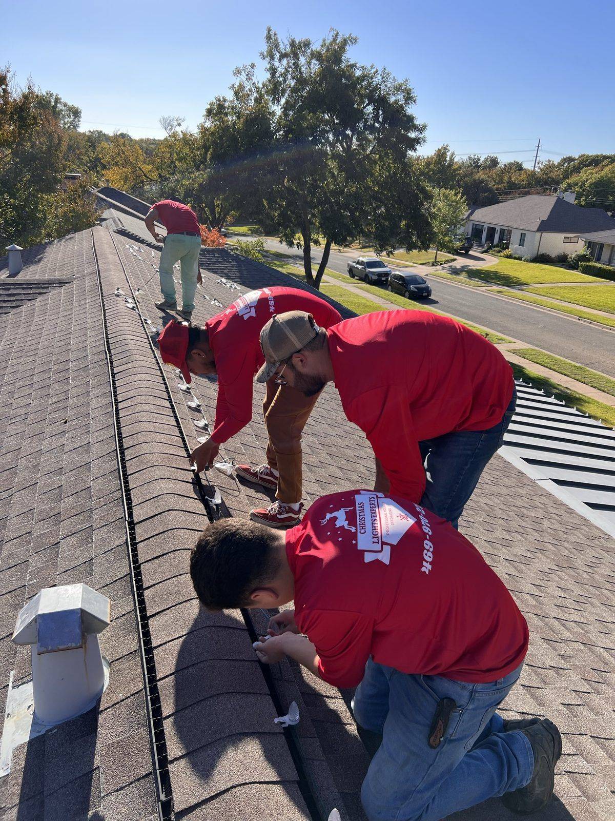 Christmas Light Installation crew Dallas TX in branded red shirts Christmas Light Installation crew Dallas TX in branded red shirts