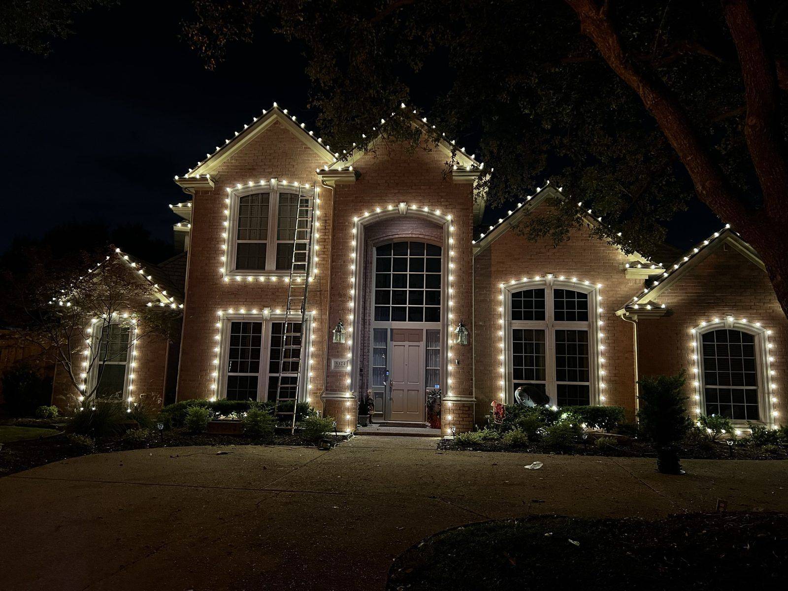 Christmas lights Allen TX brick two-story home warm white Christmas lights Allen TX brick two-story home warm white