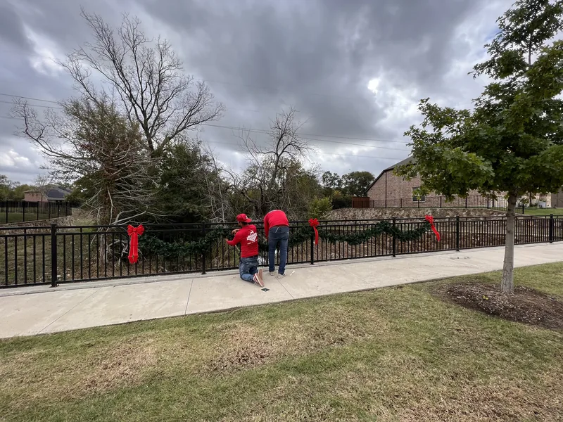 Commercial Christmas light installation DFW β professional crew installing holiday lighting and garland