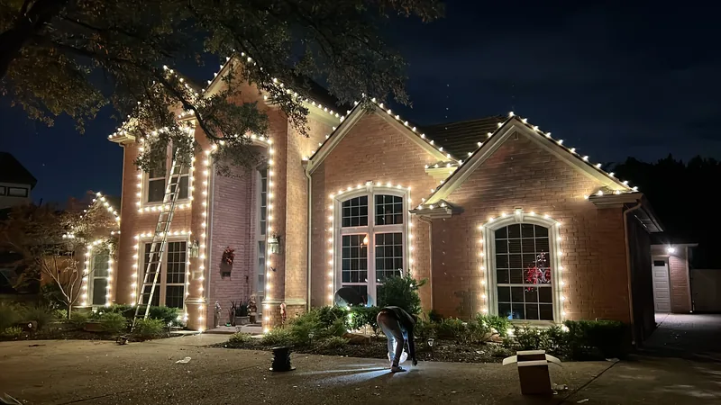 Warm white Christmas light roofline tracing the dome turret and arches of a Mediterranean estate in Fort Worth, TX
