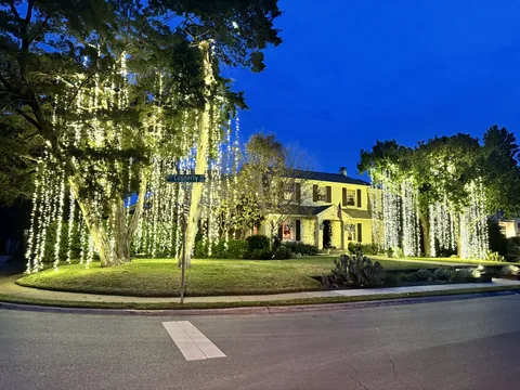 Warm white C9 LED roofline on a Highland Park brick traditional