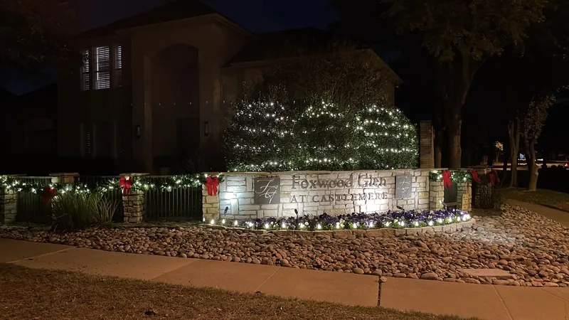 HOA Christmas light installation DFW โ lit monument entrance for a master-planned community