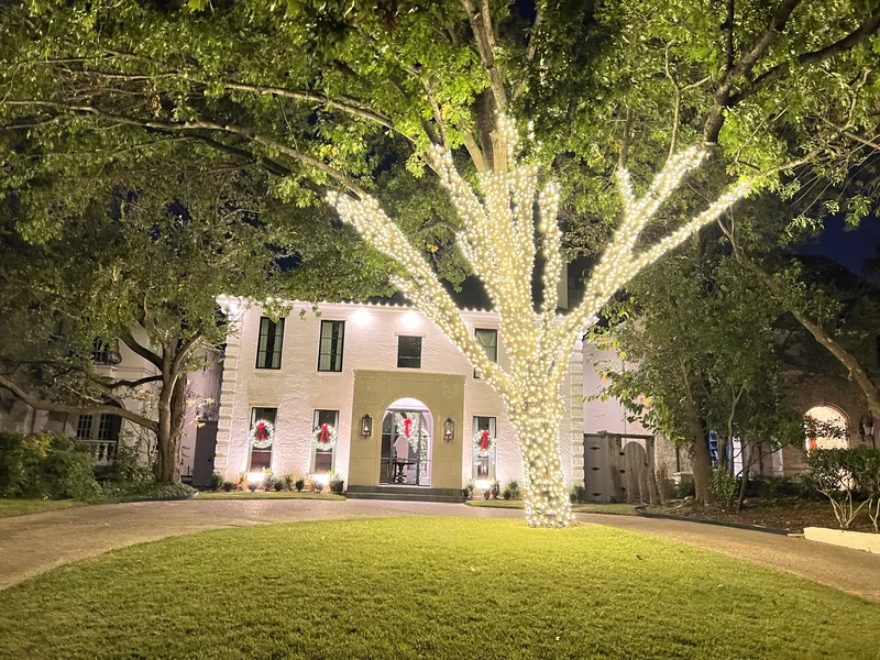 Christmas light installation Lewisville TX — multicolor roofline and path lighting on a brick home