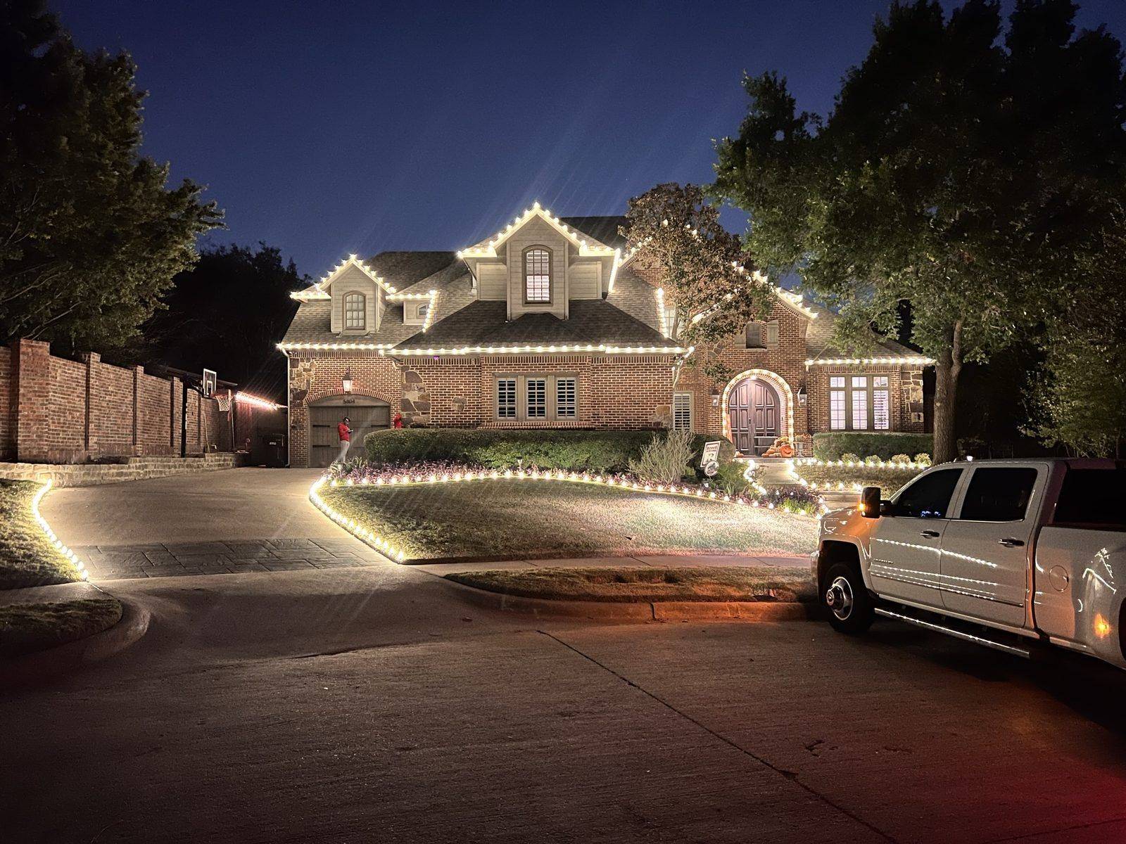 Luxury Christmas light installation Frisco TX Mediterranean villa with topiary trees Luxury Christmas light installation Frisco TX Mediterranean villa with topiary trees