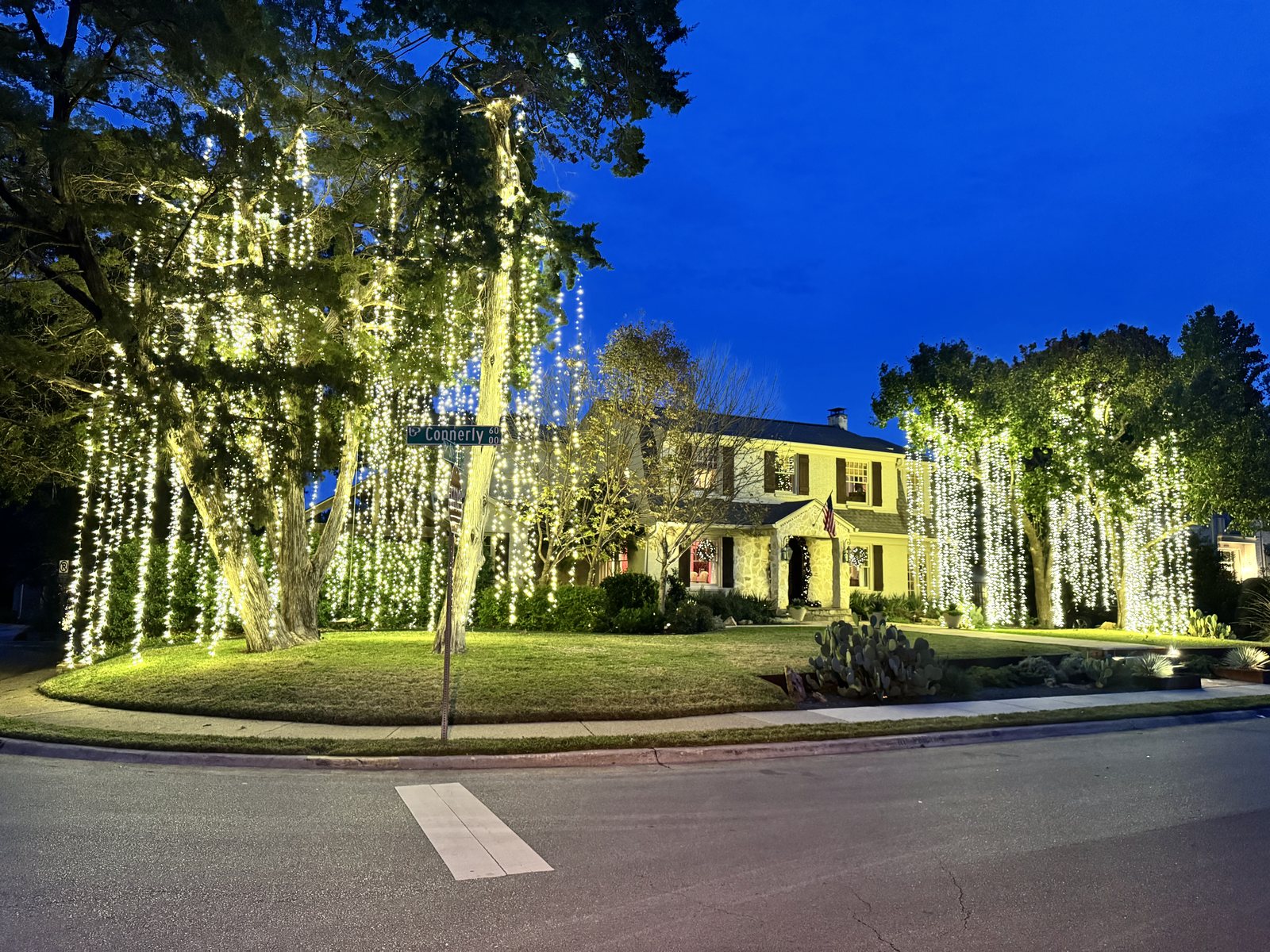 Christmas light installation Highland Park TX — warm white roofline on an estate home